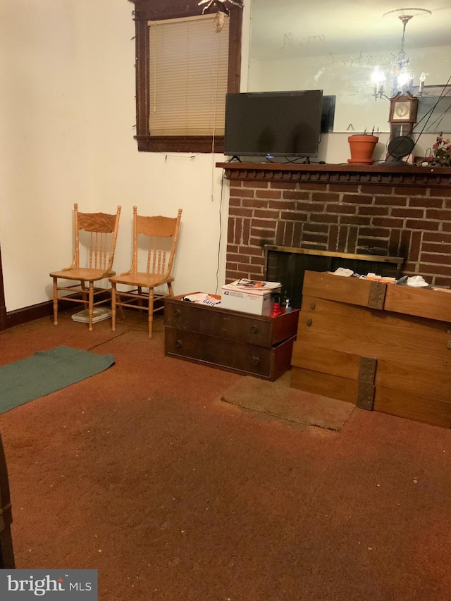 interior space featuring a brick fireplace, carpet, and an inviting chandelier