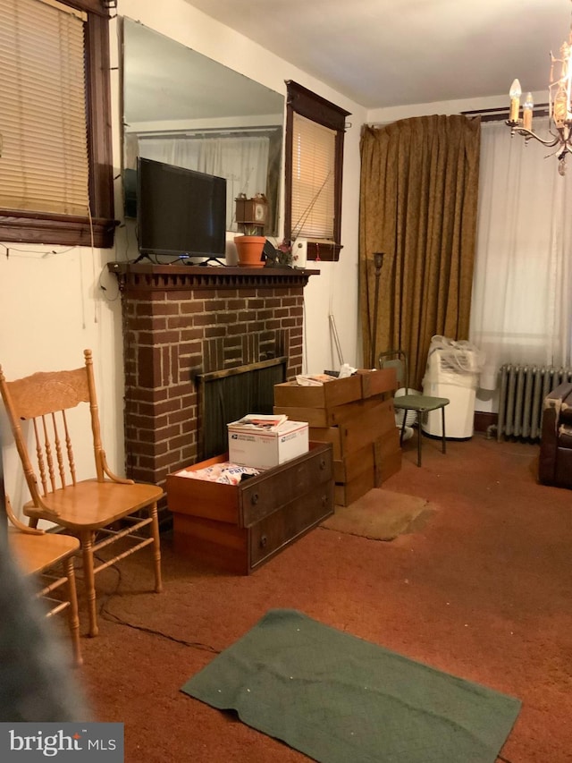 living area featuring carpet flooring, radiator heating unit, and a brick fireplace