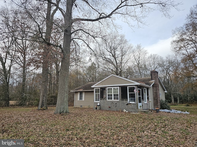 view of front of house featuring a sunroom