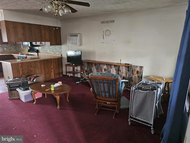 interior space with ceiling fan, dark carpet, a textured ceiling, and a wall unit AC