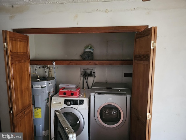 laundry area with water heater and independent washer and dryer