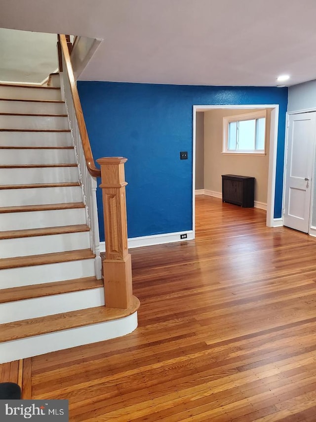 stairs featuring wood-type flooring