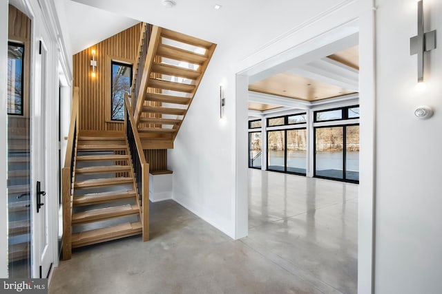 stairs with wood walls and concrete flooring