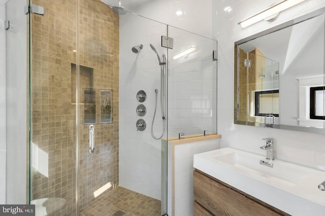 bathroom featuring vanity, an enclosed shower, and tile walls