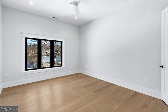 unfurnished room featuring ceiling fan and light hardwood / wood-style flooring