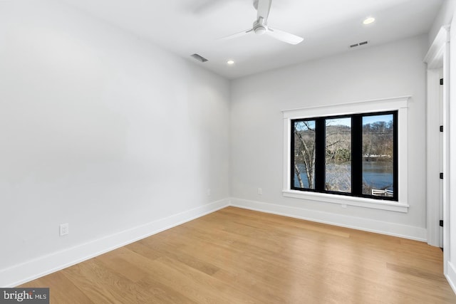 empty room featuring ceiling fan and light hardwood / wood-style flooring