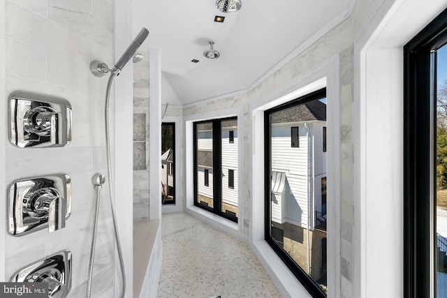 bathroom featuring a tile shower, french doors, and plenty of natural light