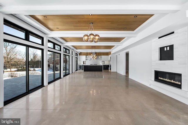 hall featuring wooden ceiling, beamed ceiling, concrete floors, and a notable chandelier