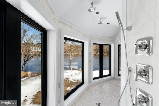 entryway with a water view, ornamental molding, and french doors