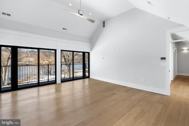 unfurnished living room featuring hardwood / wood-style floors, ceiling fan, and high vaulted ceiling