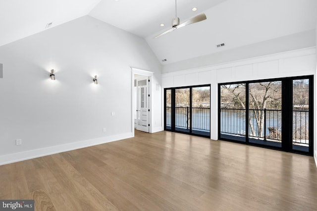 unfurnished living room featuring ceiling fan, high vaulted ceiling, and hardwood / wood-style flooring