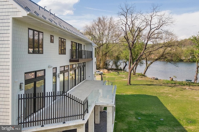 view of yard featuring a water view and a balcony