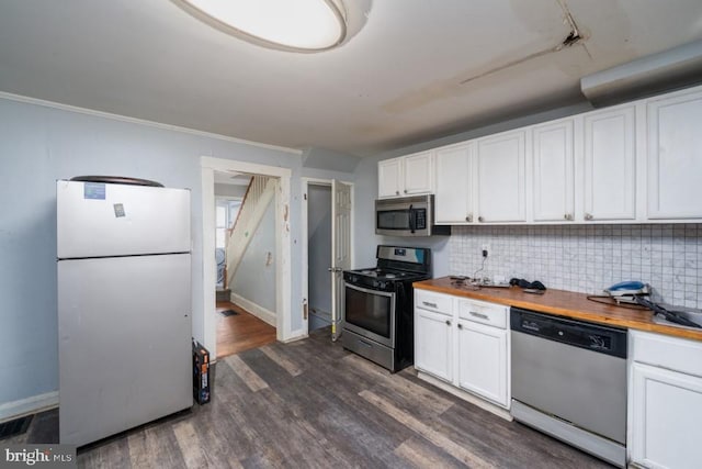 kitchen featuring wood counters, dark hardwood / wood-style flooring, stainless steel appliances, and white cabinetry