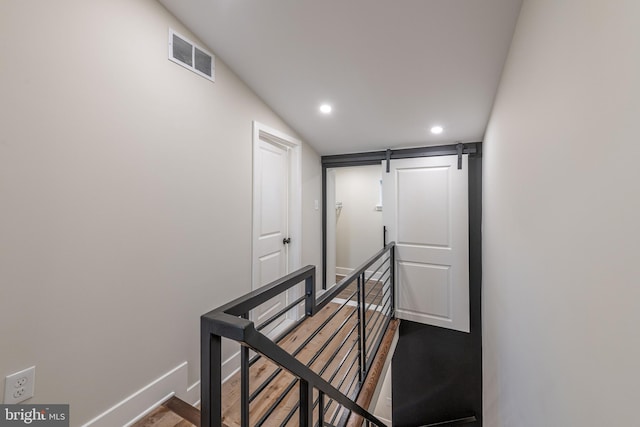 stairs with hardwood / wood-style floors and vaulted ceiling