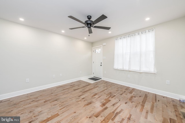 foyer with ceiling fan and light hardwood / wood-style floors