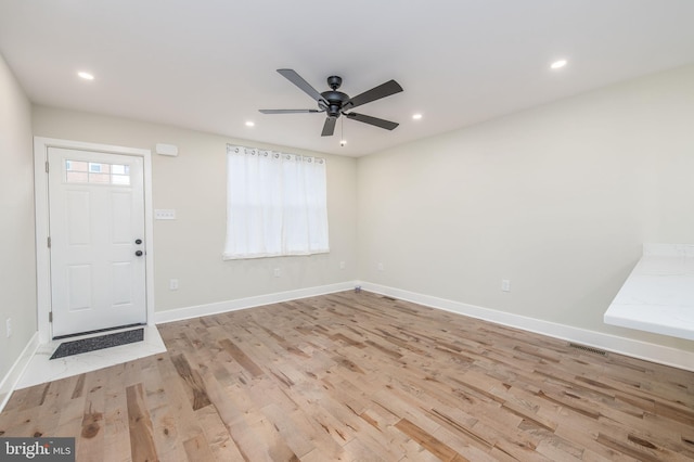 entryway with ceiling fan and light hardwood / wood-style floors