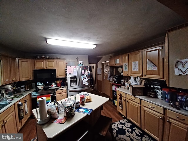 kitchen featuring dark wood-type flooring, a textured ceiling, and black appliances