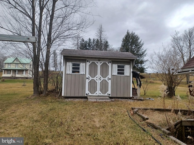 view of outdoor structure featuring a lawn