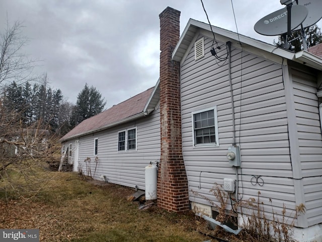 view of side of property with a yard