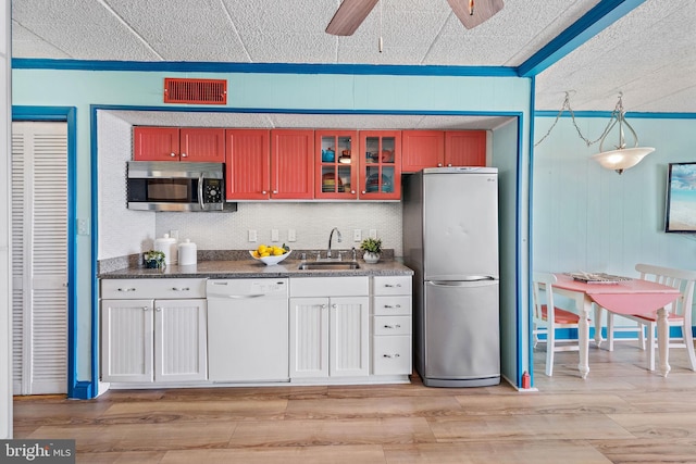 kitchen with ceiling fan, light hardwood / wood-style floors, and stainless steel appliances