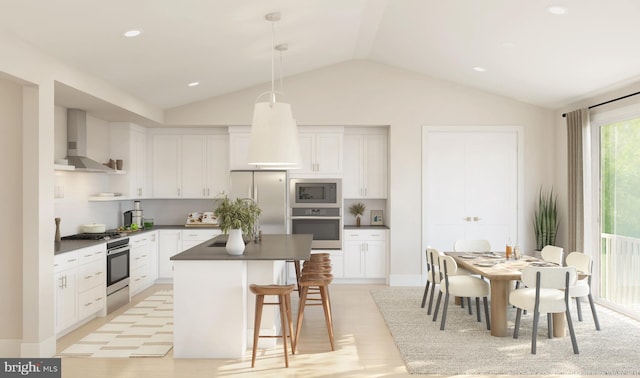 kitchen with white cabinets, wall chimney exhaust hood, pendant lighting, and appliances with stainless steel finishes