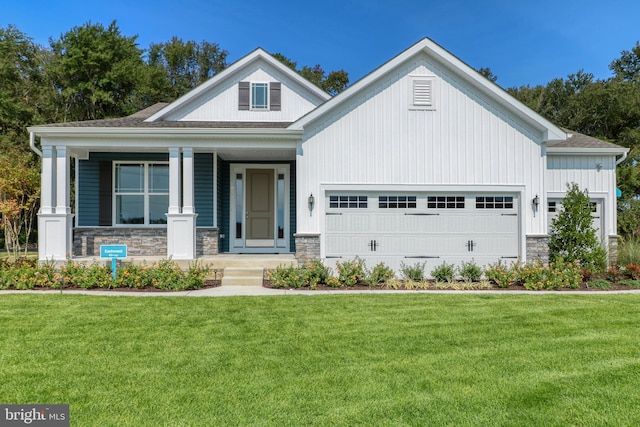 view of front of home with a garage and a front lawn