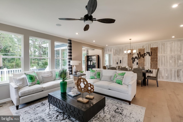 living room with light hardwood / wood-style floors, plenty of natural light, and ornamental molding