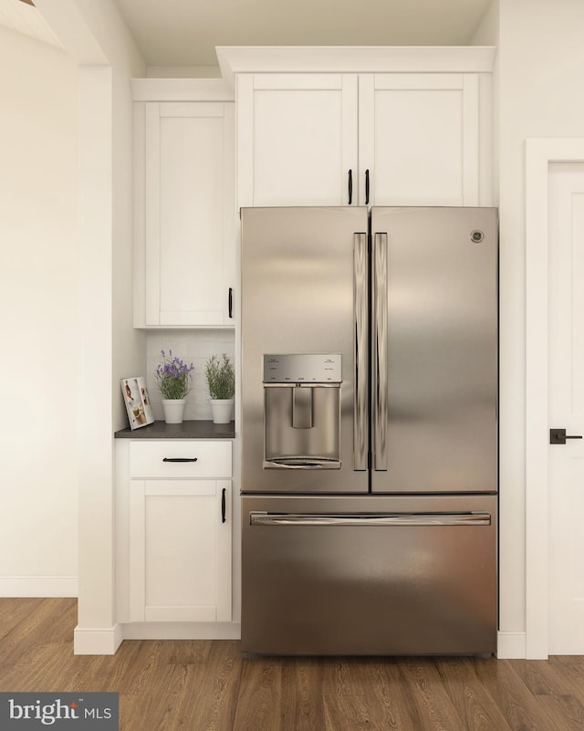 kitchen featuring white cabinets, stainless steel fridge with ice dispenser, and dark hardwood / wood-style flooring