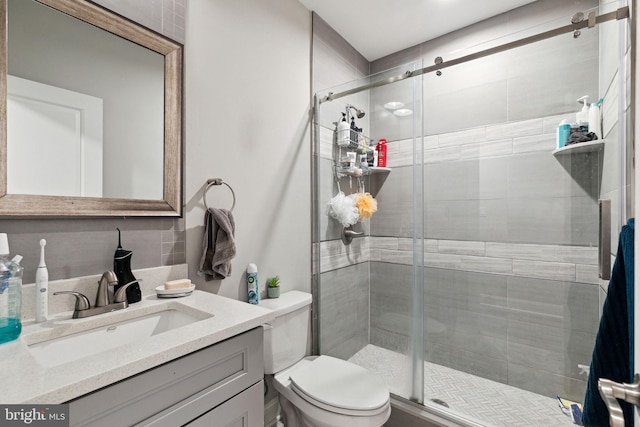 bathroom with vanity, toilet, and walk in shower