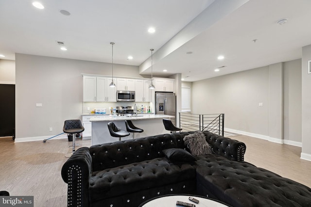 living room featuring sink and light wood-type flooring