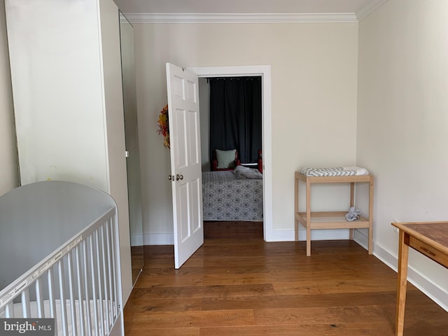 hallway with ornamental molding and hardwood / wood-style flooring