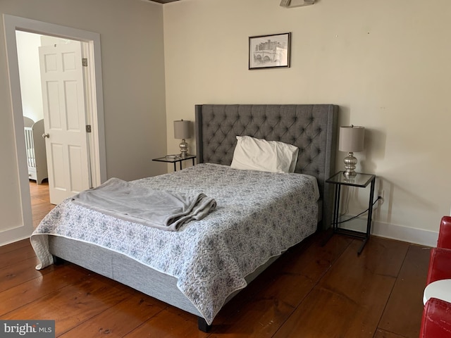 bedroom with dark wood-type flooring