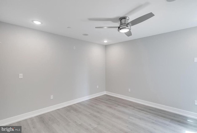 empty room with ceiling fan and light hardwood / wood-style floors