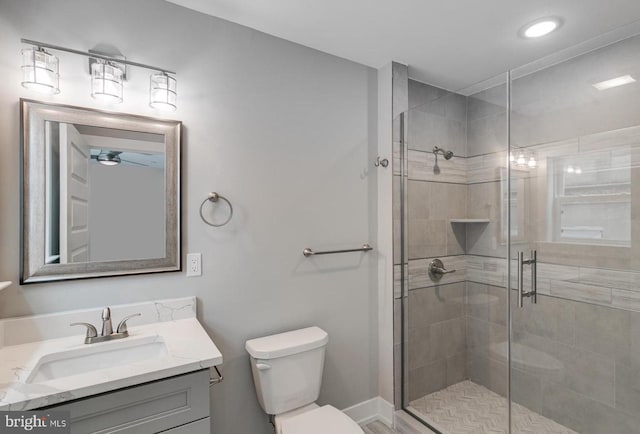 bathroom featuring vanity, toilet, and an enclosed shower