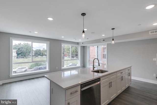 kitchen featuring white cabinets, stainless steel dishwasher, an island with sink, decorative light fixtures, and dark hardwood / wood-style flooring