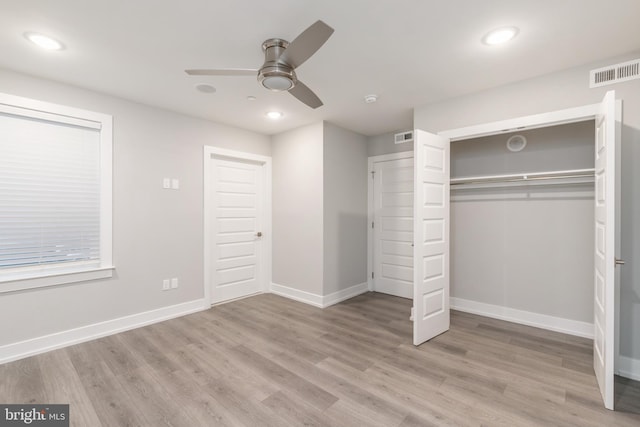 unfurnished bedroom featuring ceiling fan, a closet, and light hardwood / wood-style flooring