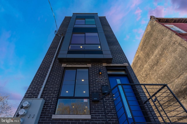 view of outdoor building at dusk