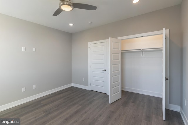 unfurnished bedroom featuring a closet, ceiling fan, and dark wood-type flooring