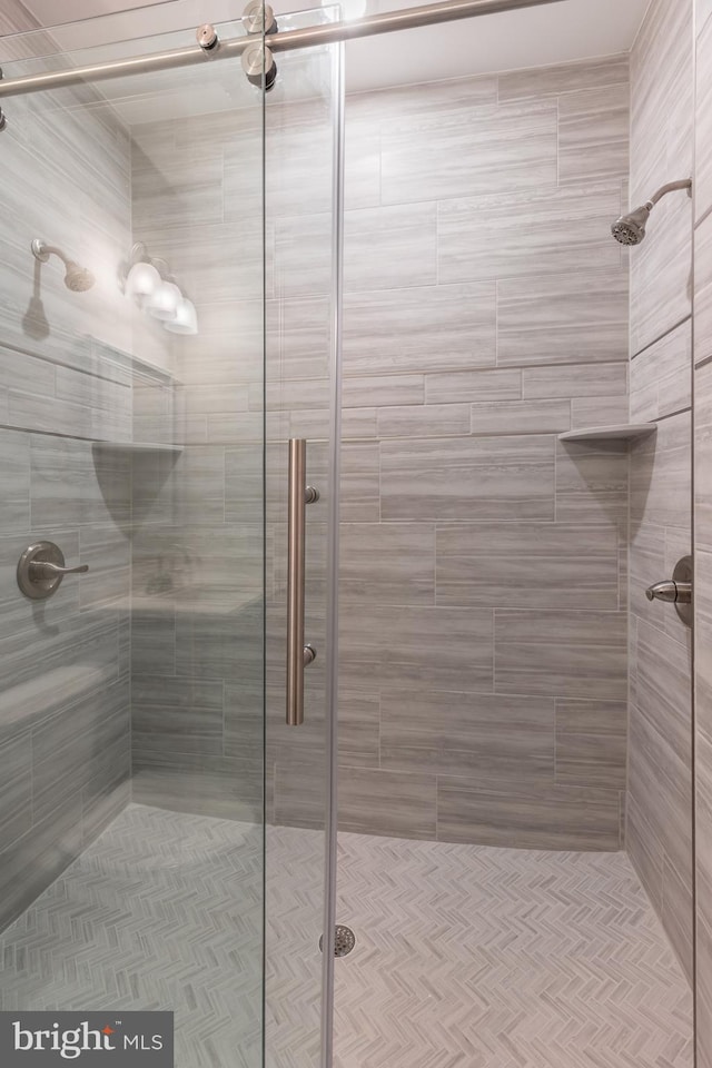 bathroom with a shower with door