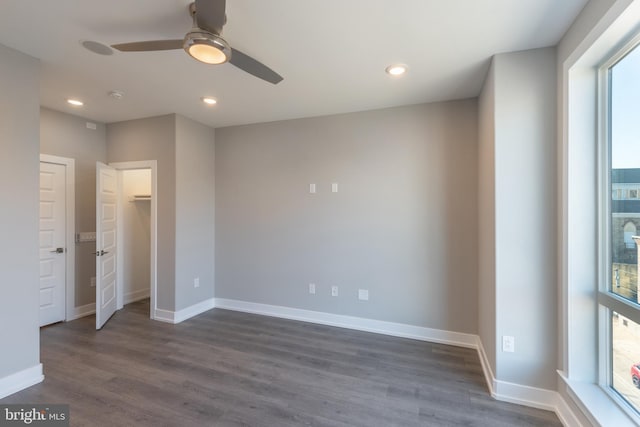 unfurnished bedroom with dark hardwood / wood-style floors, ceiling fan, and a closet