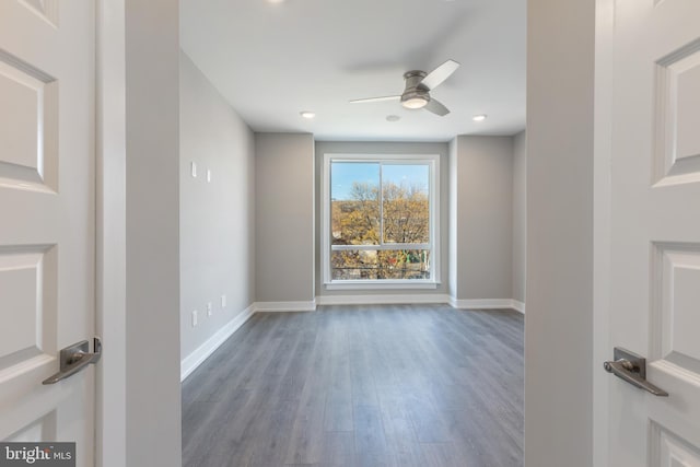 spare room with dark hardwood / wood-style flooring and ceiling fan