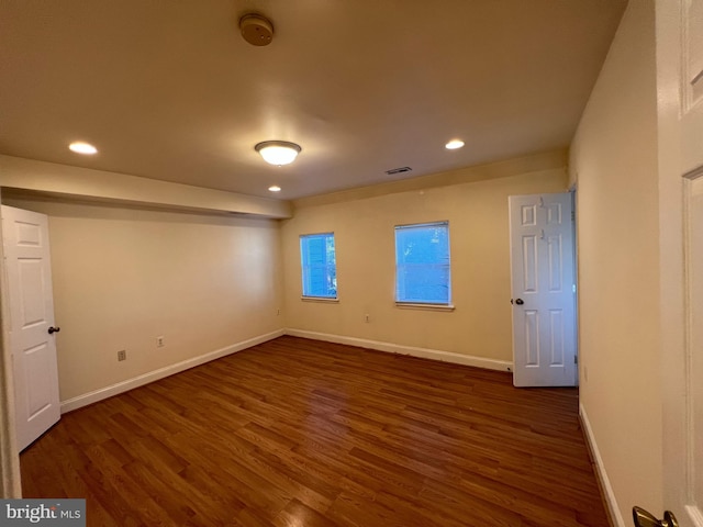 unfurnished room featuring dark hardwood / wood-style flooring