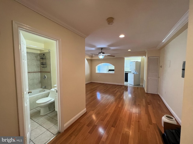 hallway with crown molding and hardwood / wood-style floors