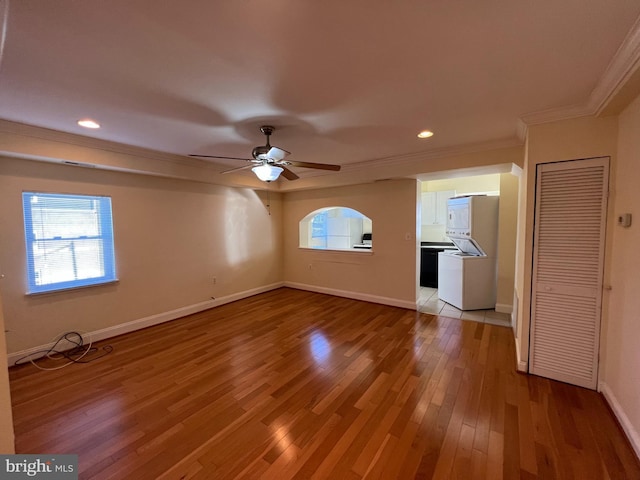 empty room with ceiling fan, light hardwood / wood-style flooring, and ornamental molding