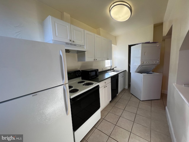 kitchen featuring black appliances, sink, white cabinets, and stacked washer and dryer