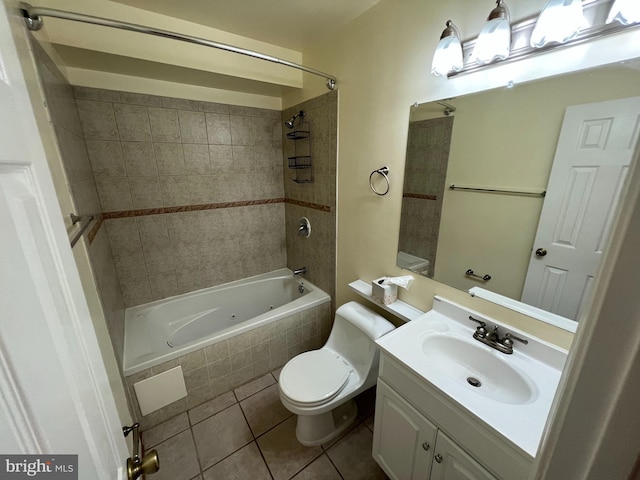 full bathroom with toilet, tile patterned flooring, vanity, and tiled shower / bath