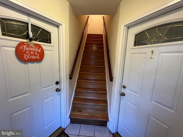 stairway featuring tile patterned flooring