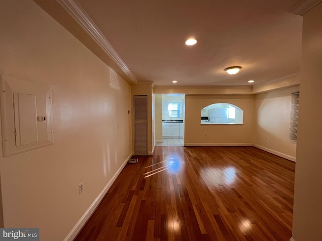 interior space with electric panel, crown molding, and dark hardwood / wood-style flooring