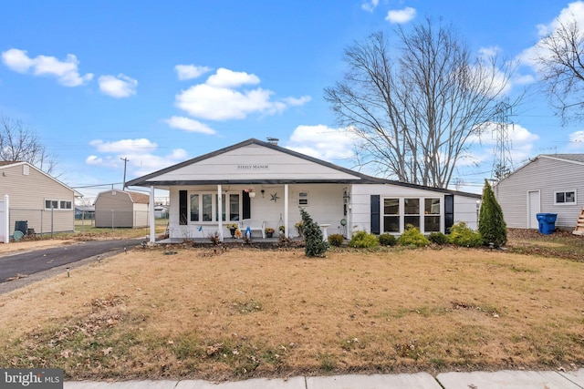 view of front of home with covered porch and a front yard