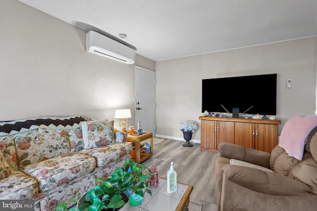 living room featuring light wood-type flooring and a wall unit AC